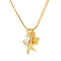Gold necklace with starfish, pearl, and shell pendant on a white background
