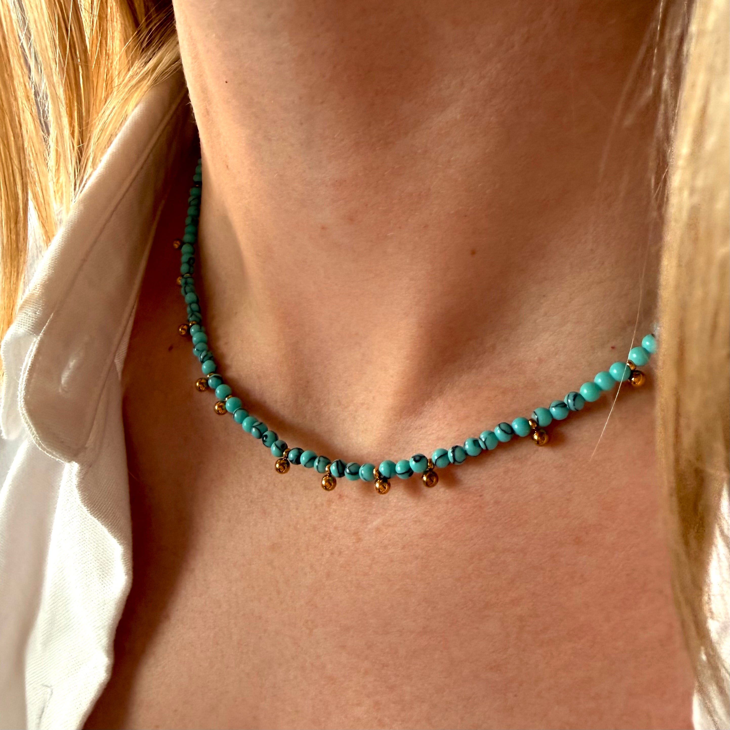Turquoise stone necklace worn by a person with blonde hair. turquoise bead necklace gold, gold bead necklace, beach jewelry necklace