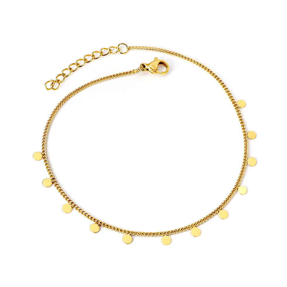 Gold bracelet with small round pendants on a white background