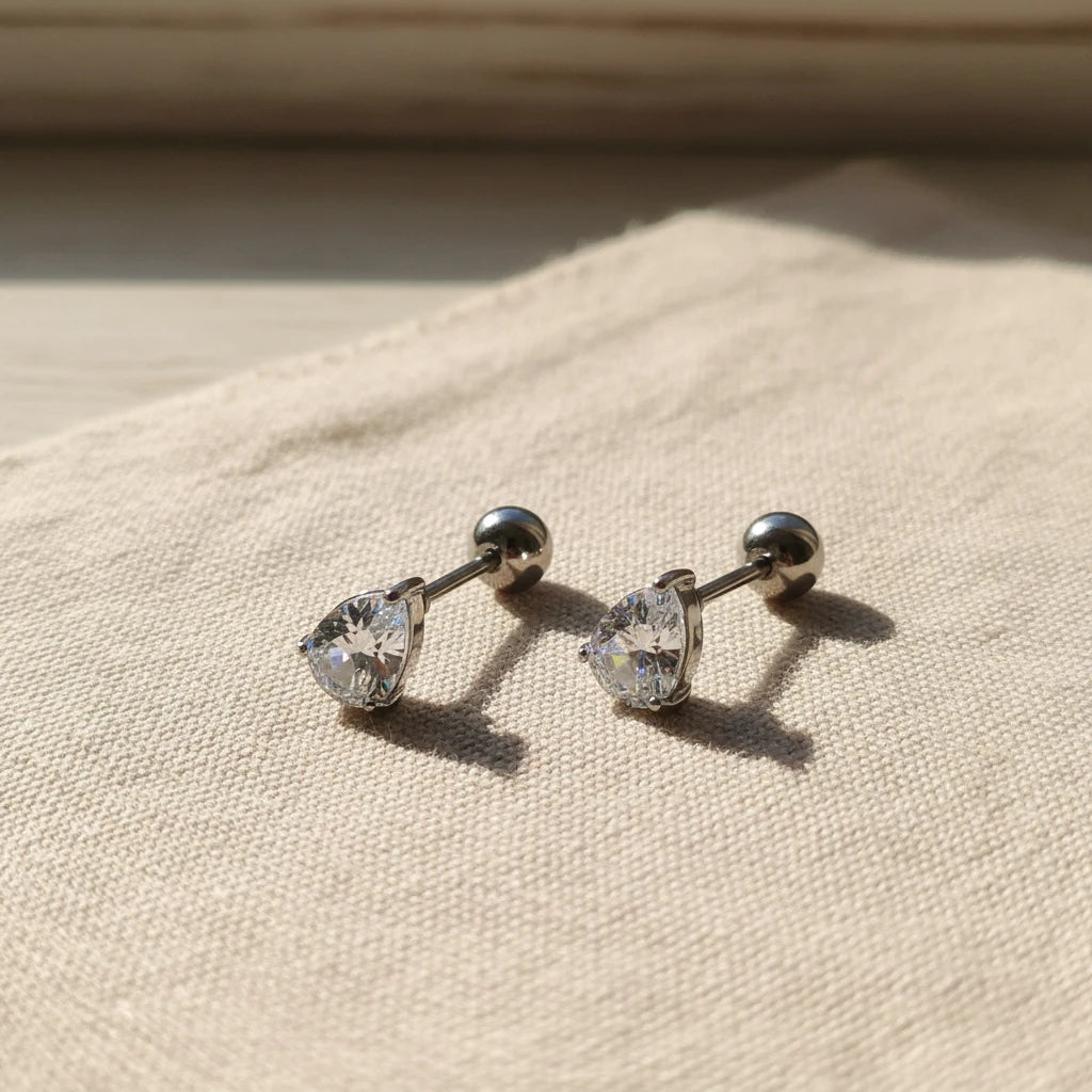 Pair of silver stud zirconia teardrop earrings on a white background. teardrop zirconia stud earrings, gold stud earrings, dainty gold earrings