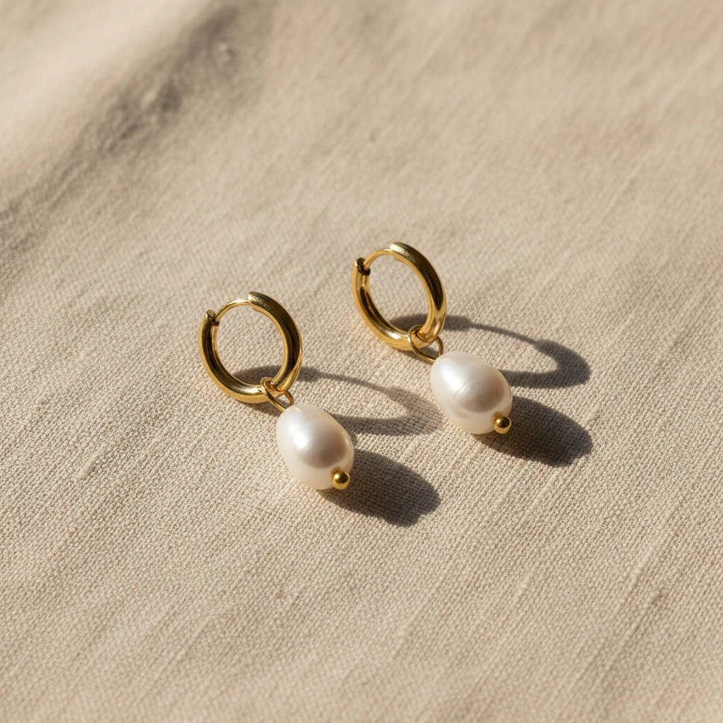 Gold hoop drop earrings with freshwater pearls on a white background. Pearl drop huggie earrings gold, pearl hoop earrings, dainty gold earrings