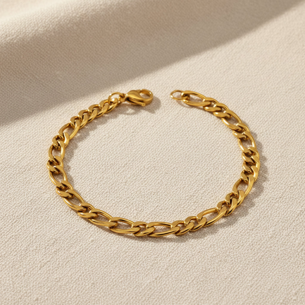 Gold figaro chain bracelet on a white background. Gold link bracelet, classic chain bracelet