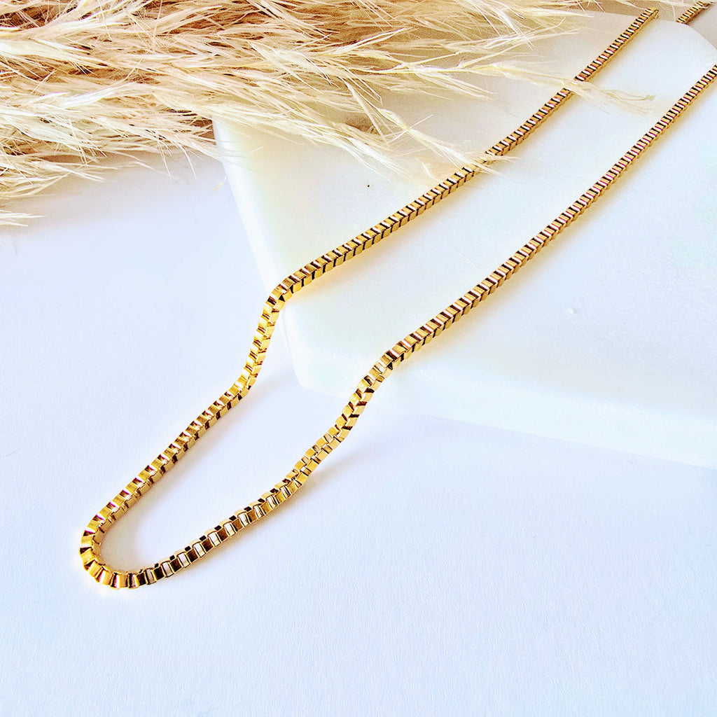 Gold box chain on a white surface with a natural background 18k stainless steel necklaces