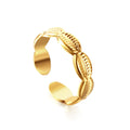 Gold open ring with conch shell design on a white background