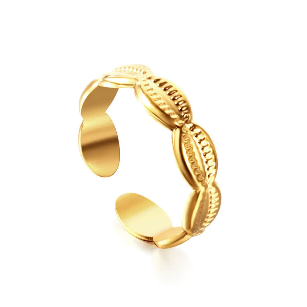 Gold open ring with conch shell design on a white background