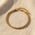Gold rope chain bracelet on a white background. rope chain bracelet gold, gold chain bracelet, textured bracelet