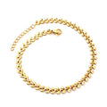 Gold fishbone chain anklet on a white background