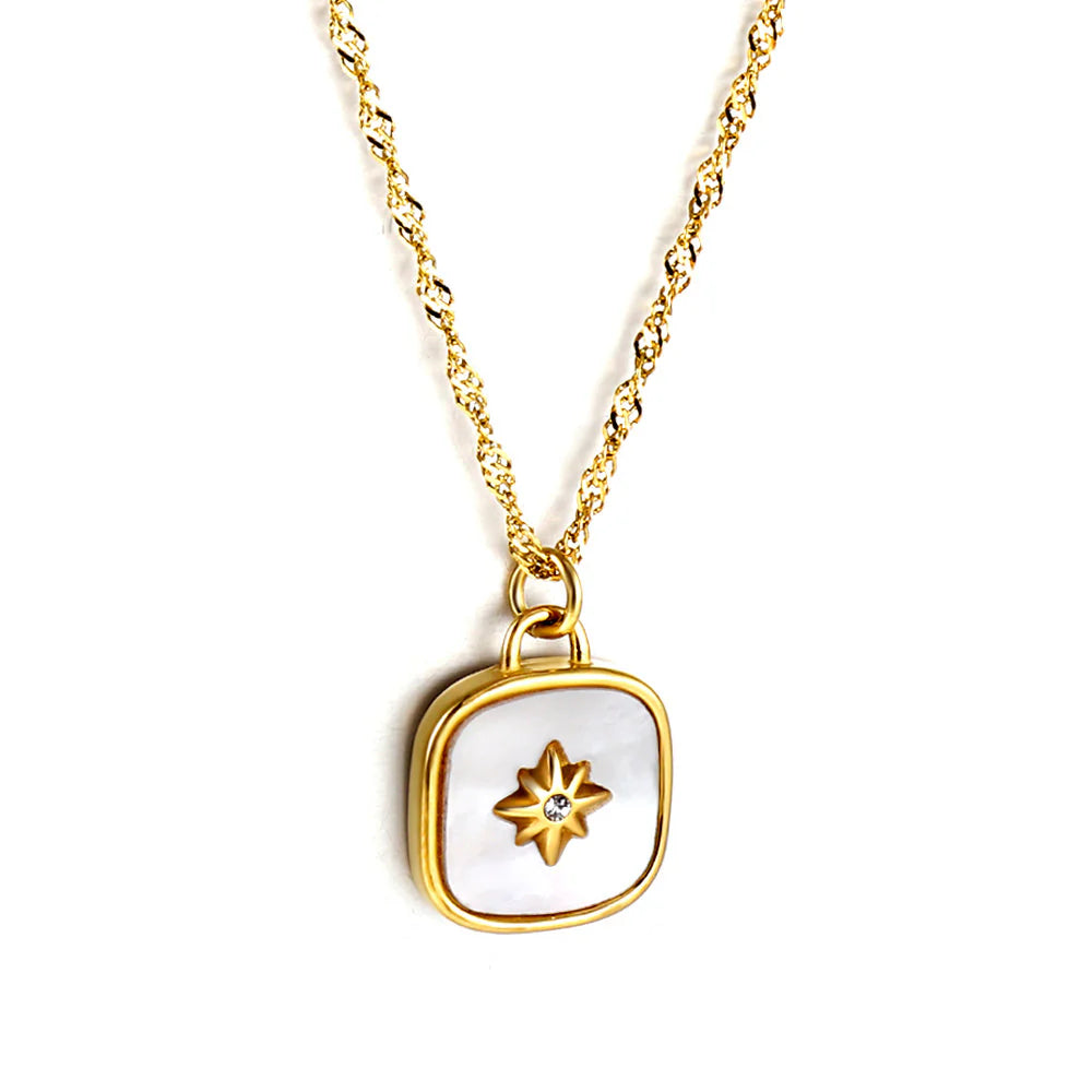 Gold necklace with a star-shaped pendant on a white background
