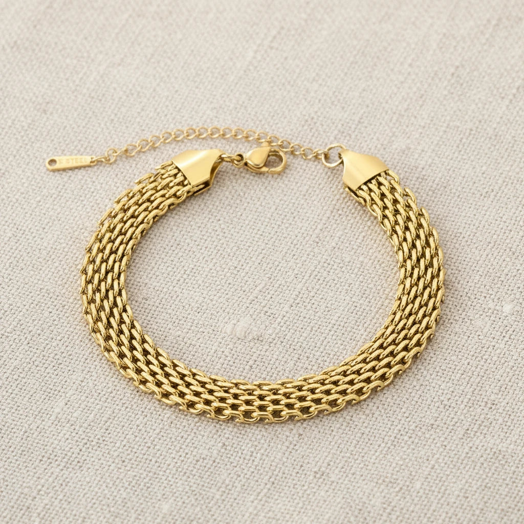 Gold mesh chain bracelet on a white background. 