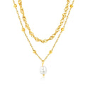 Two gold necklaces with a pearl pendant on a white background. double chain pearl necklace gold, layered pearl necklace, gold pearl pendant necklace