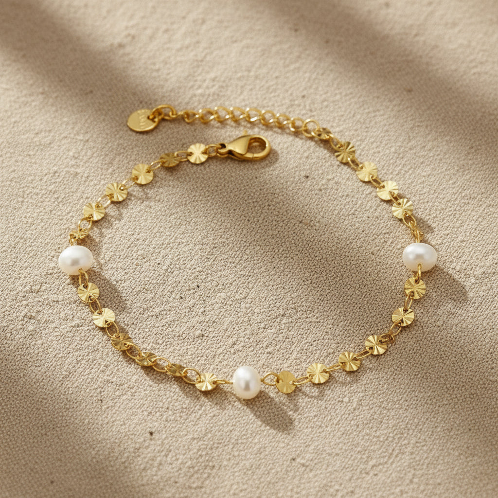 Gold bracelet with pearls on a white background