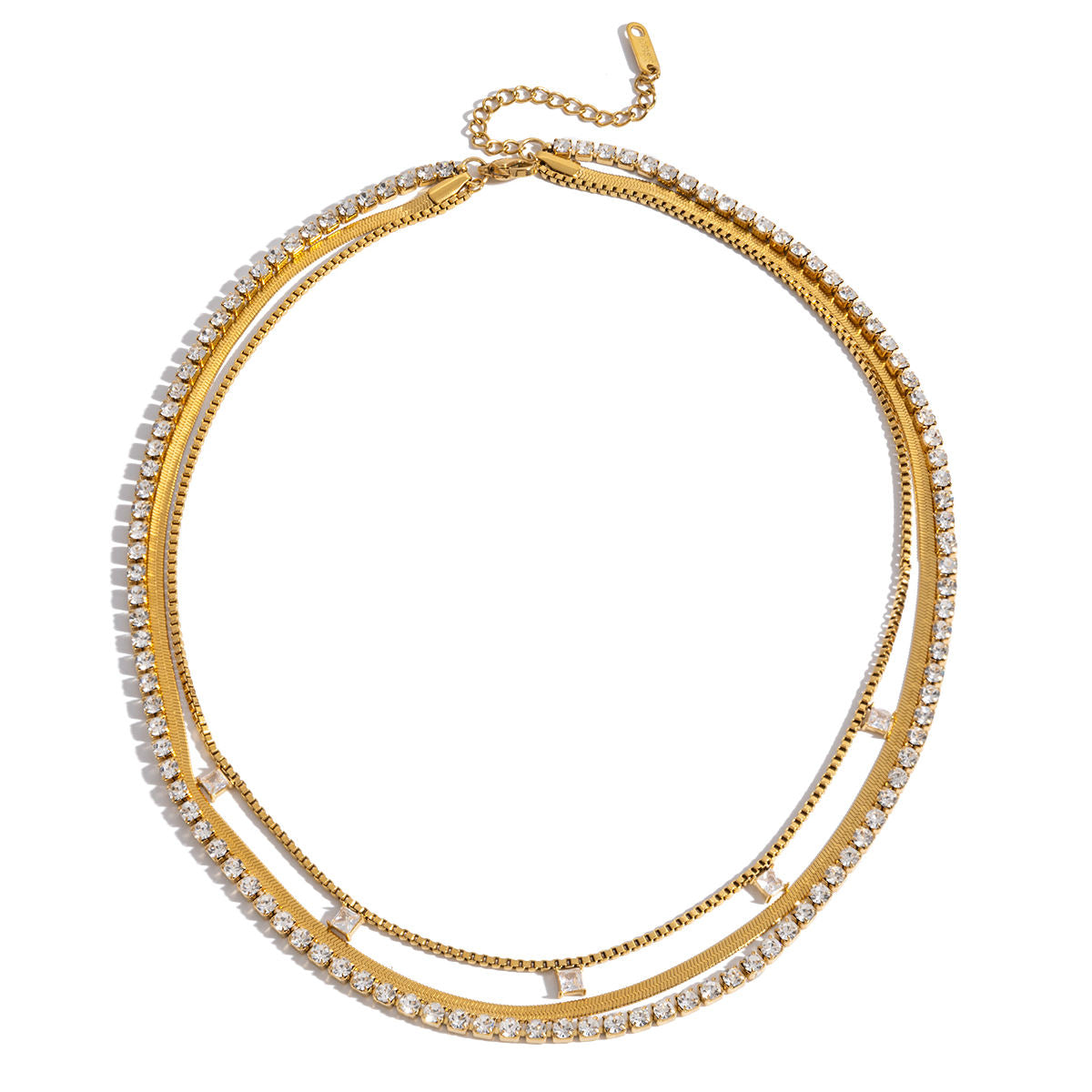 Close-up of a person wearing multiple gold necklaces with cubic zirconia diamonds and herringbone chain necklace. triple layered necklace gold, zirconia layered necklace, gold layering necklace