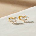 crescent shape gold stud earrings with zirconia detail. Minimalist stud.
