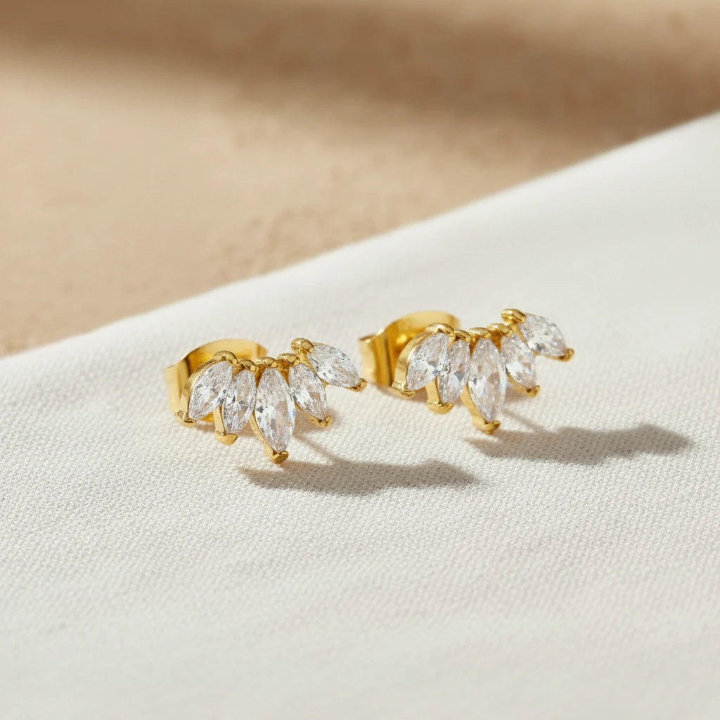 crescent shape gold stud earrings with zirconia detail. Minimalist stud.