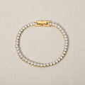 Gold bracelet with cubic zirconia diamonds on a white background. zirconia chain bracelet gold, pavé bracelet, gold statement bracelet. Tennis bracelet