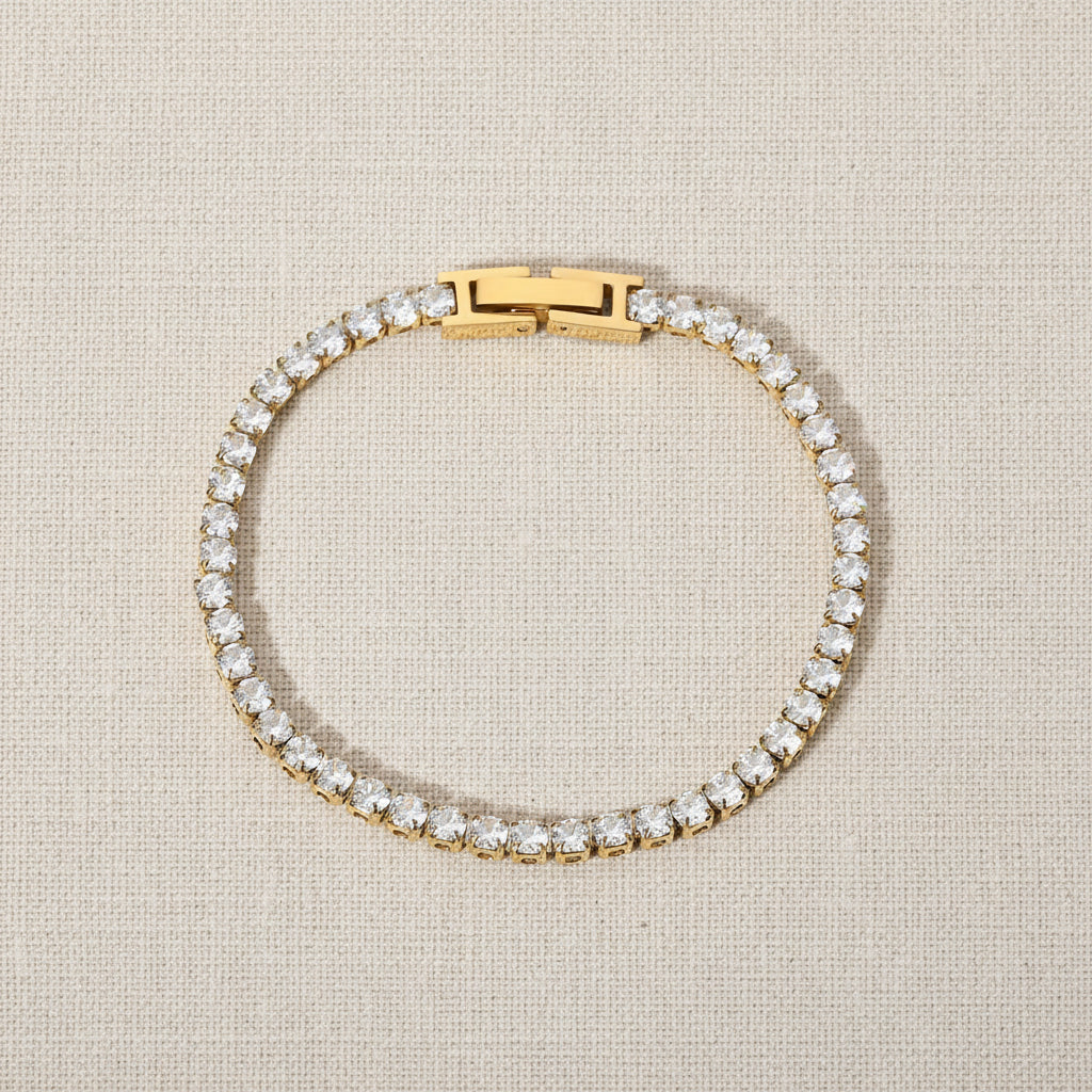 Gold bracelet with cubic zirconia diamonds on a white background. zirconia chain bracelet gold, pavé bracelet, gold statement bracelet. Tennis bracelet