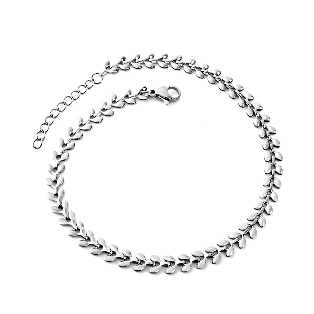 Silver fishbone bracelet with leaf-like links on a white background