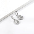 Pair of silver textured drop earrings on a white surface. silver drop earrings, vintage style earrings, statement drop earrings