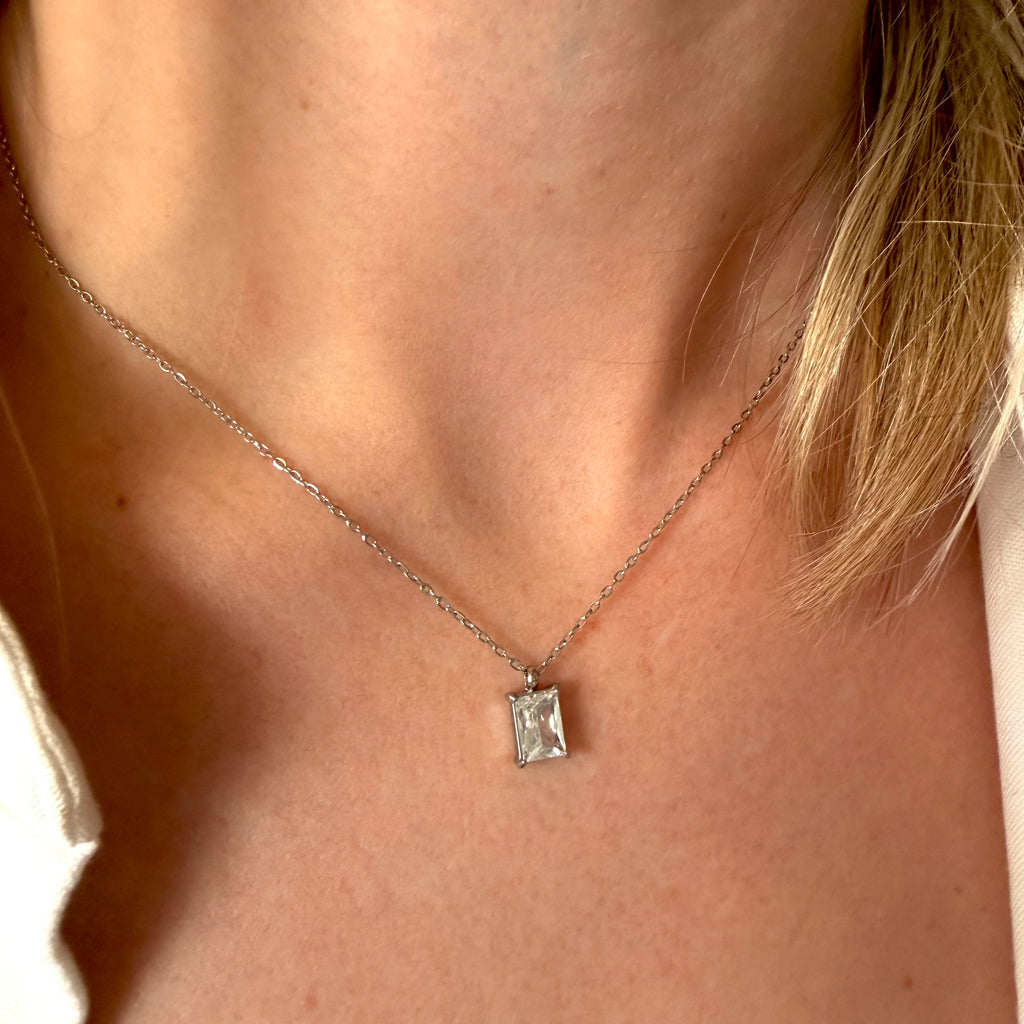 Silver necklace with a rectangular zirconia pendant on a woman's neck. rectangular zirconia necklace silver, crystal pendant necklace, minimalist silver necklace