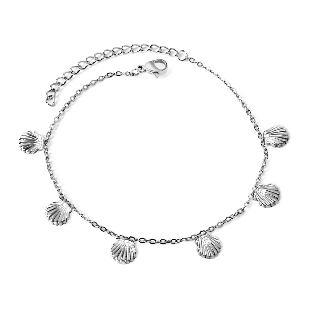 Silver anklet with seashell-shaped charms on a white background. shell charm anklet silver, beach anklet, ocean inspired anklet