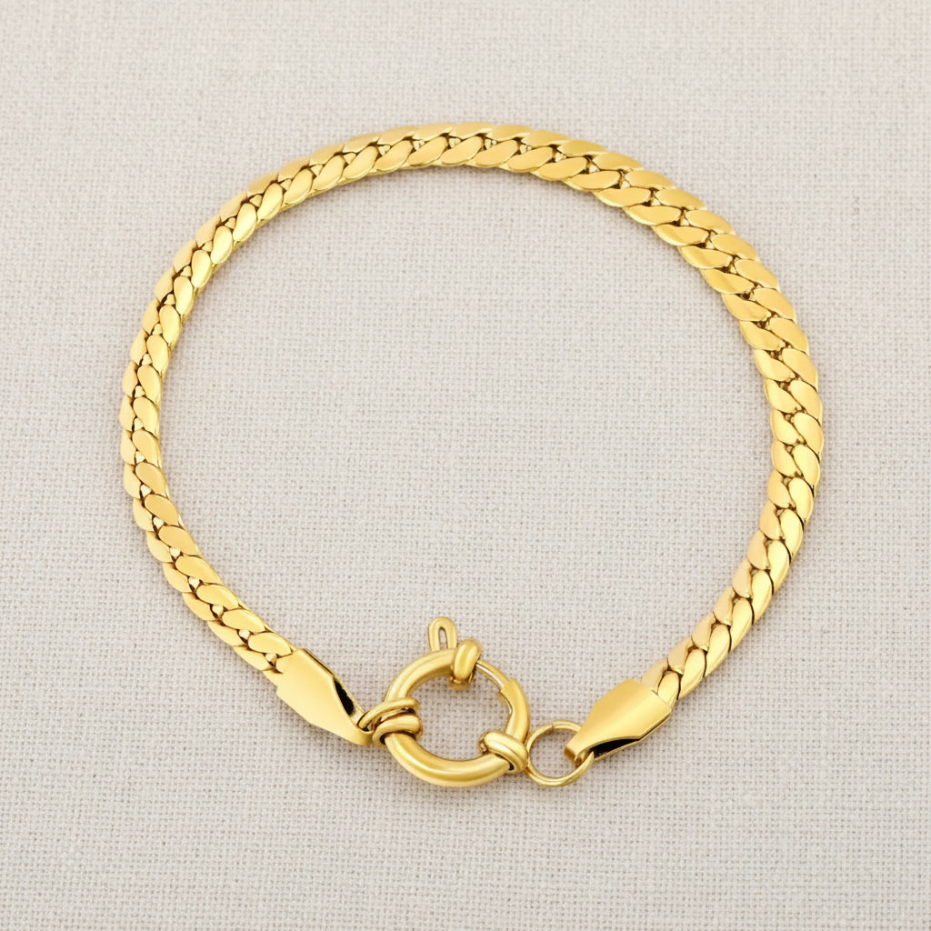 Gold cuban chain bracelet with a clasp on a white background