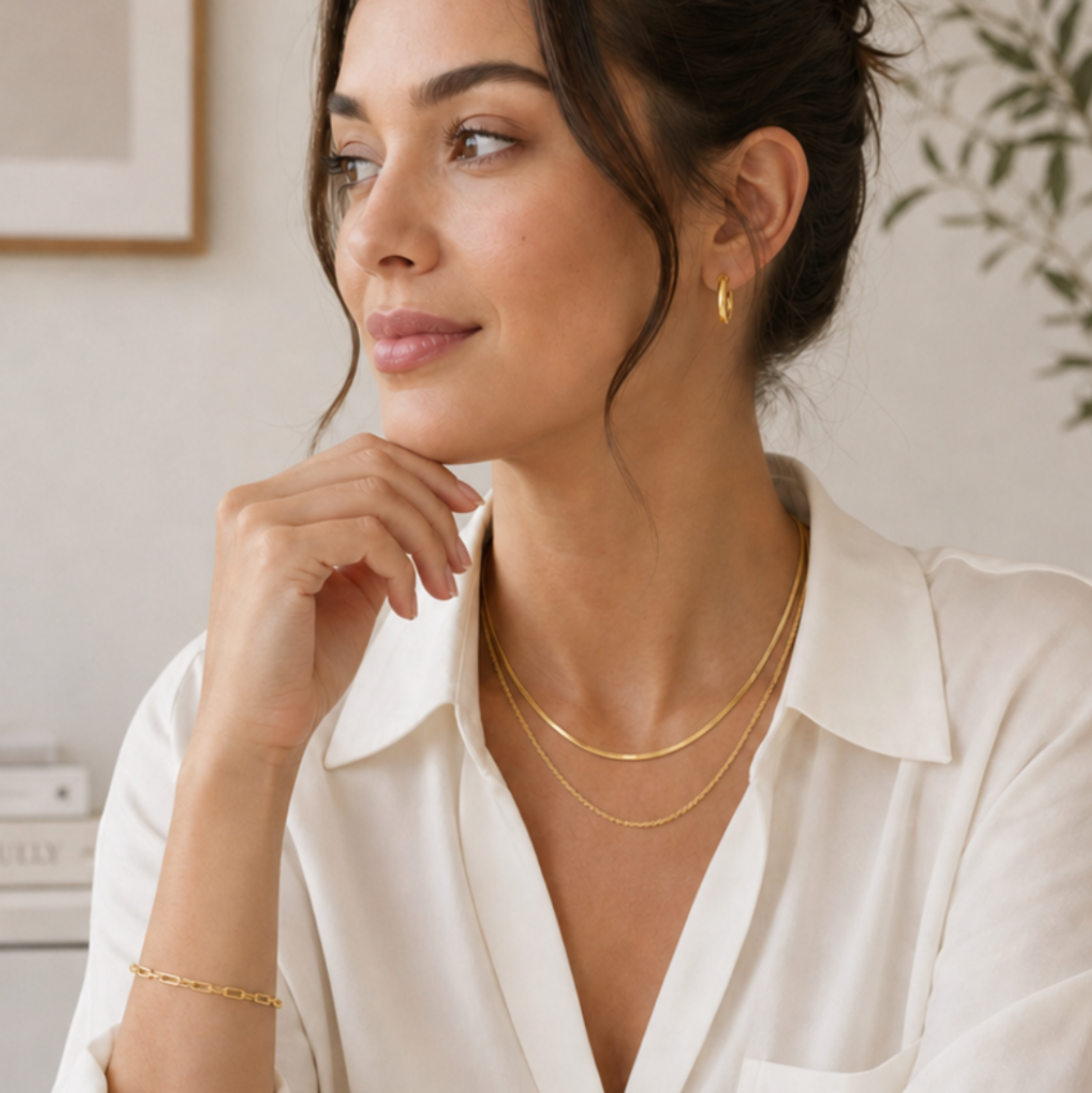 Woman sitting at her desk wearing a white blouse wearing Luna Mares necklace, bracelet and earrings. gold jewelry set everyday, minimalist jewelry bundle, gold necklace bracelet earrings set. Stainless steel jewelry