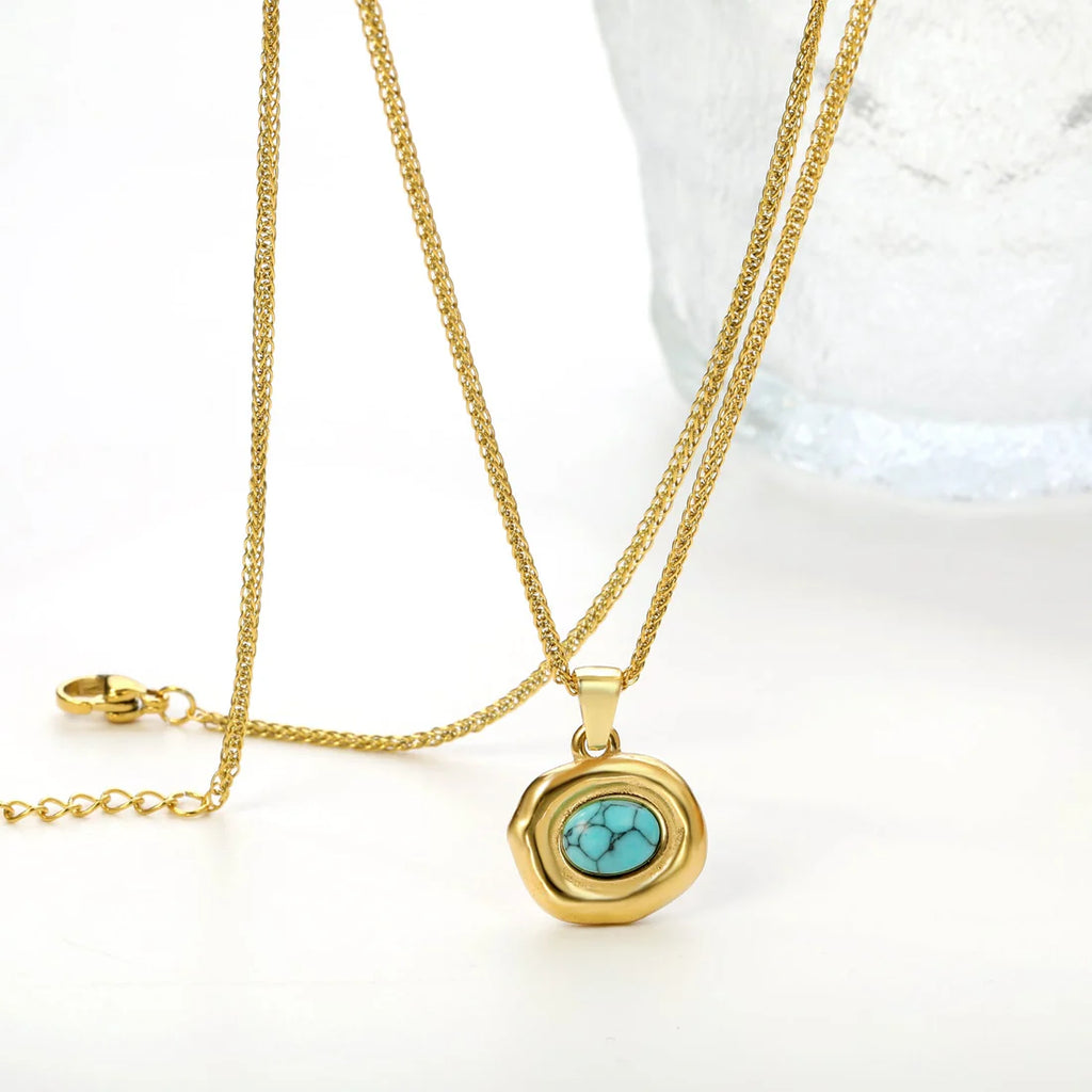 Gold necklace with a turquoise pendant on a white background. turquoise pendant necklace gold, geometric stone necklace, blue stone necklace