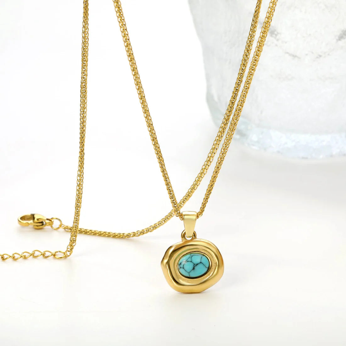 Gold necklace with a turquoise pendant on a white background. turquoise pendant necklace gold, geometric stone necklace, blue stone necklace
