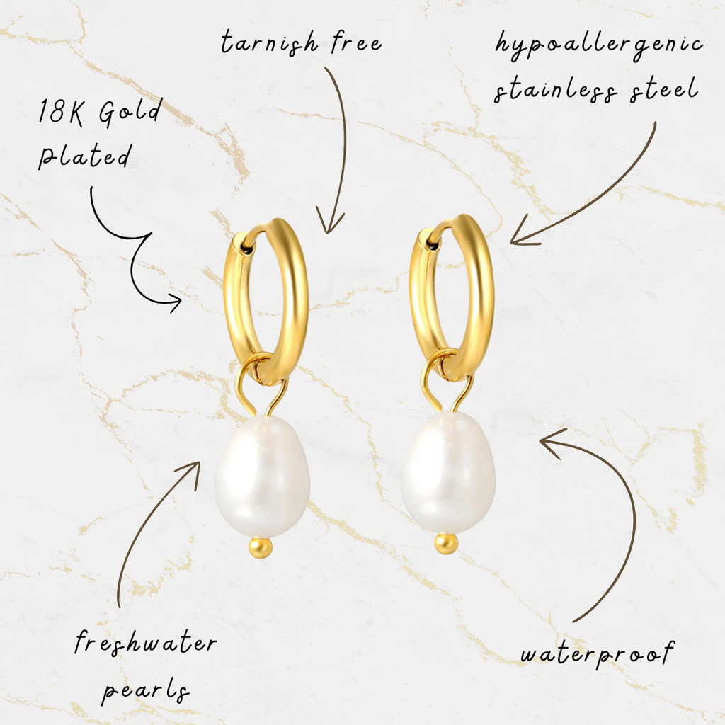 Gold hoop earrings with freshwater pearls on a marble background