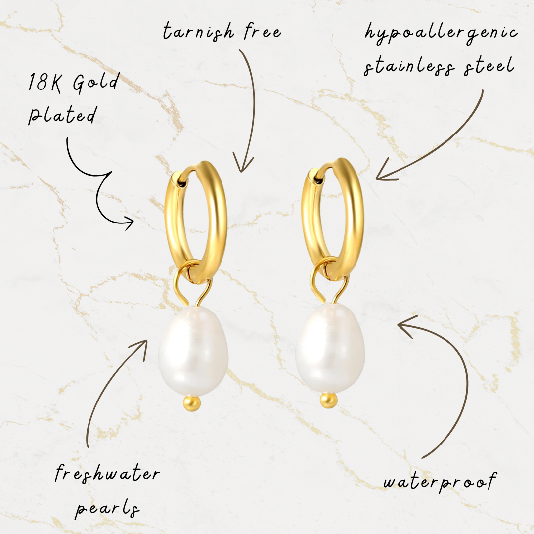 Gold hoop earrings with freshwater pearls on a marble background
