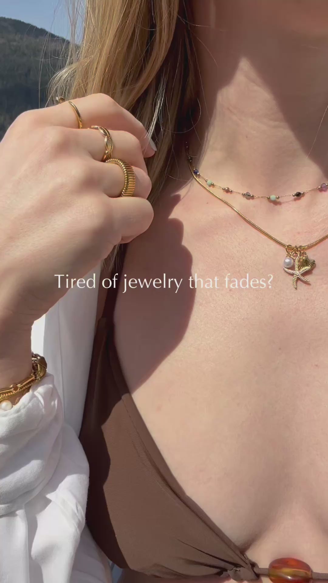 video of woman wearing gold jewelry by lake